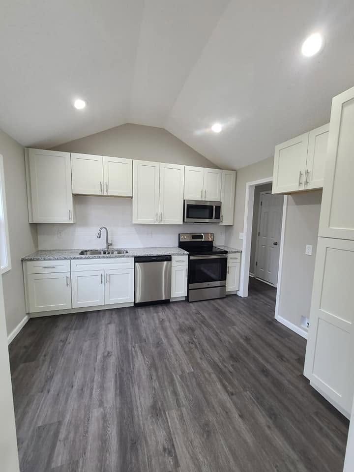 Brand-new white shaker kitchen with granite counters and stainless appliances