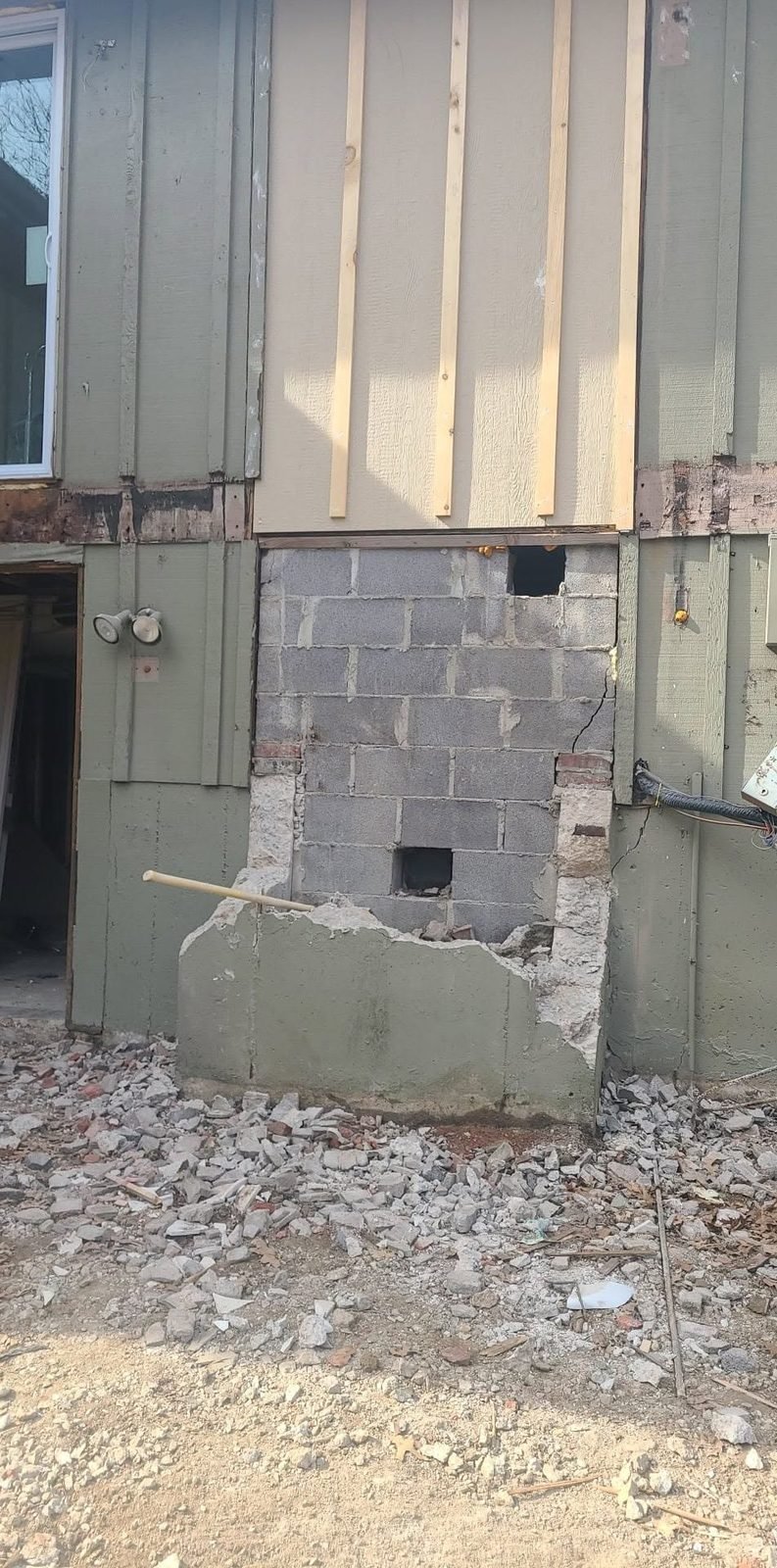 Chimney removed block by block during structural demo