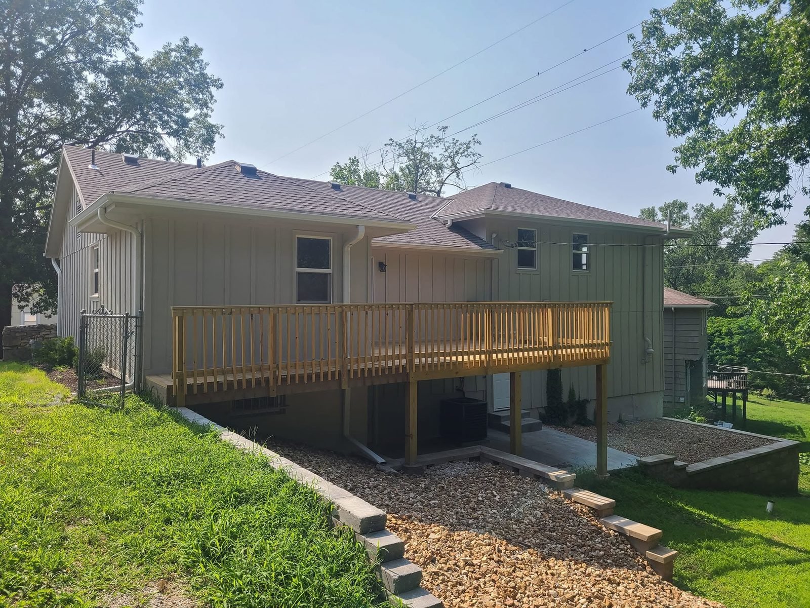 Rear exterior with brand-new deck and landscaping