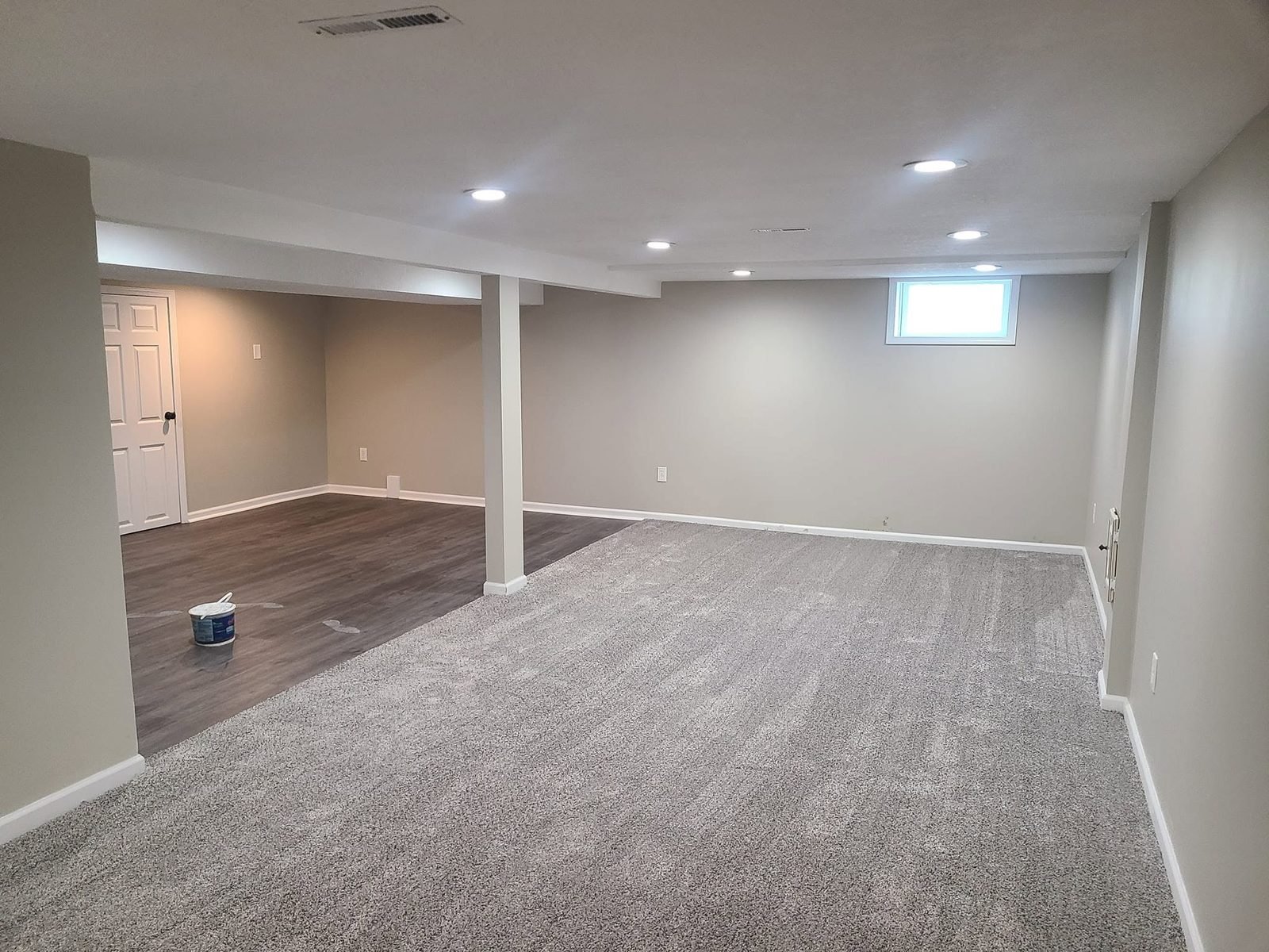 Finished basement with recessed lighting and new carpet